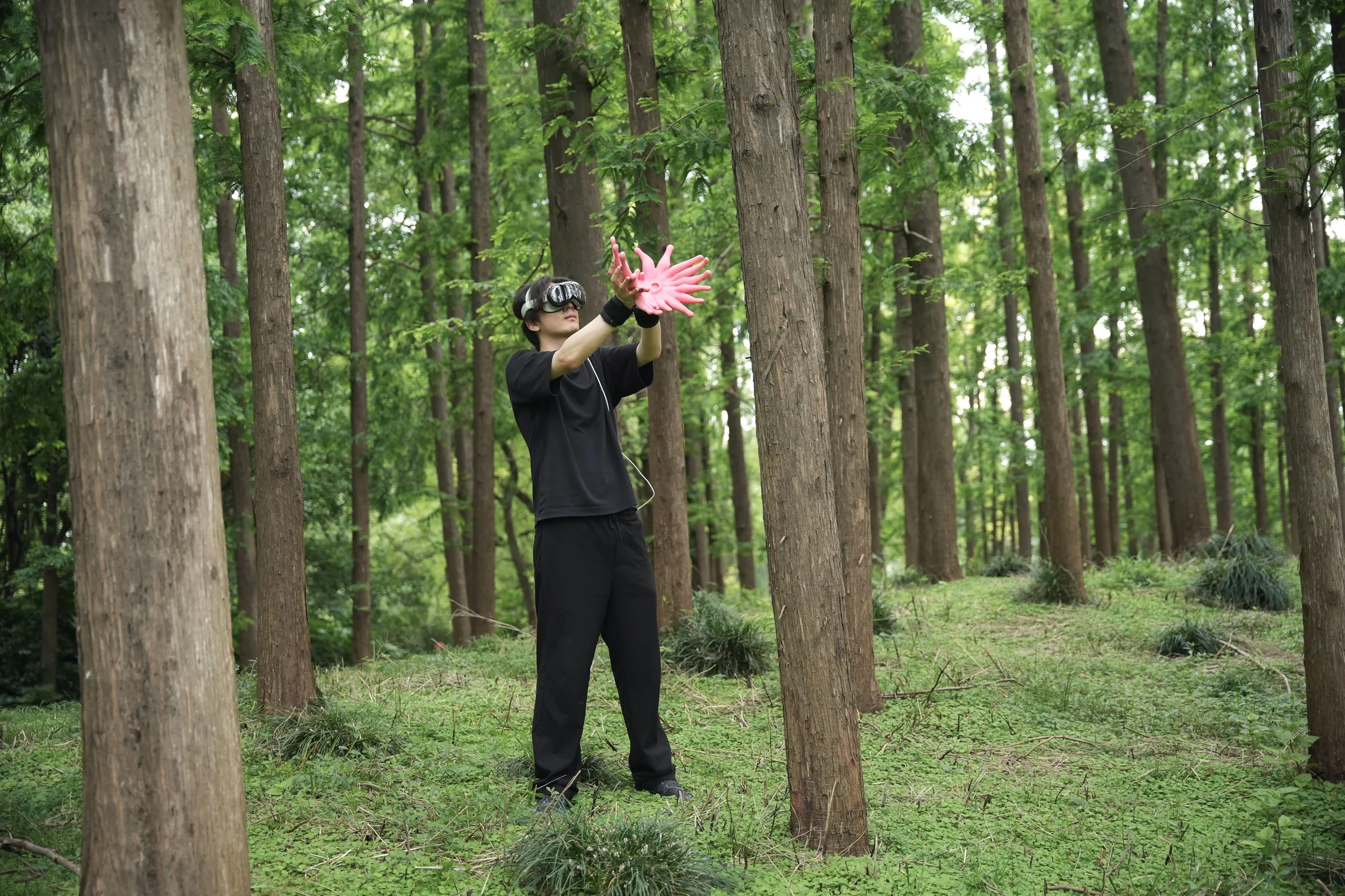 Participant wearing FeltSight gloves and headset in a forest